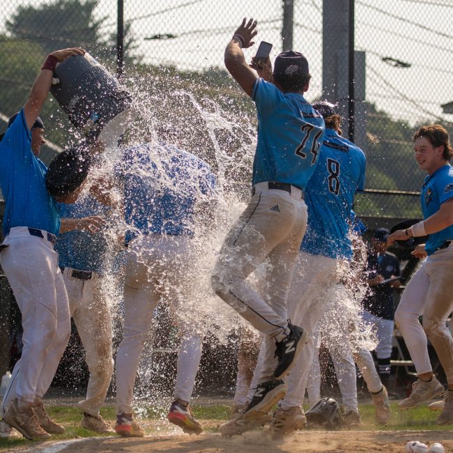Griffin Enis gets the water bucket treatment after a walk-off win