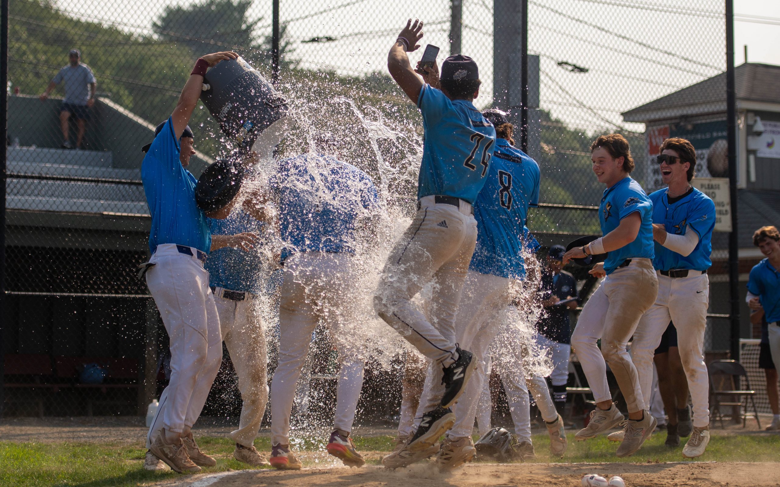 Griffin Enis gets the water bucket treatment after a walk-off win