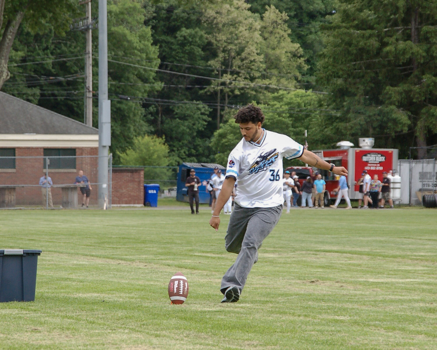 Andres Borregales kicks footballs to fans