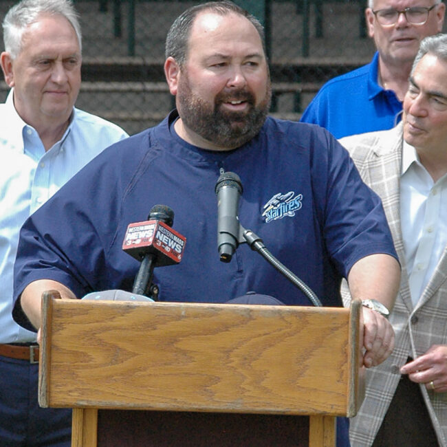 Chris Thompson speaks at Forest Park with Springfield Mayor Domenic Sarno and others looking on.
