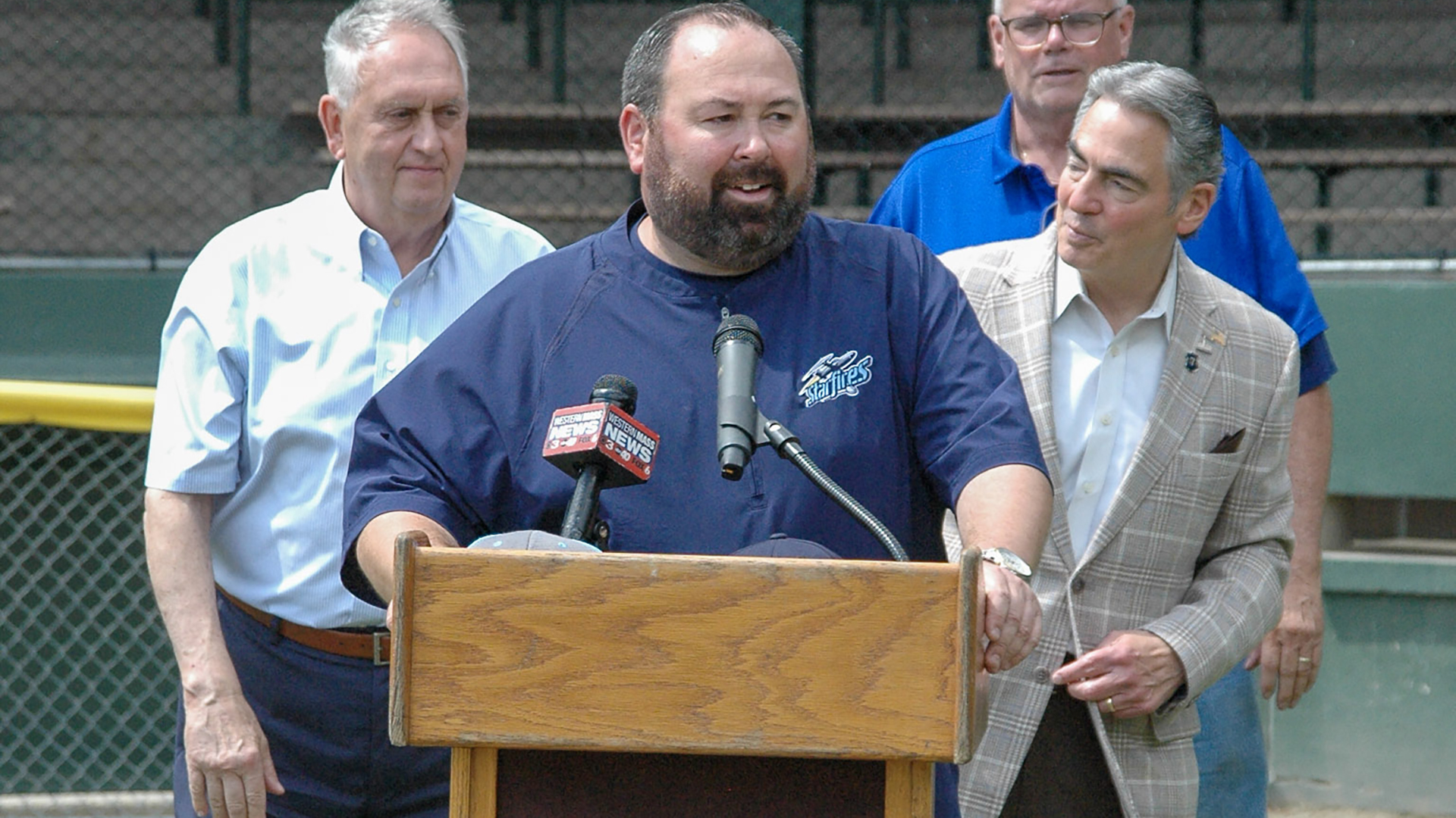 Chris Thompson speaks at Forest Park with Springfield Mayor Domenic Sarno and others looking on.